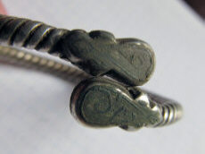 Древнерусский серебряный псевдовитой браслет с фигурными расширениями на кончиках, украшенными чернью.